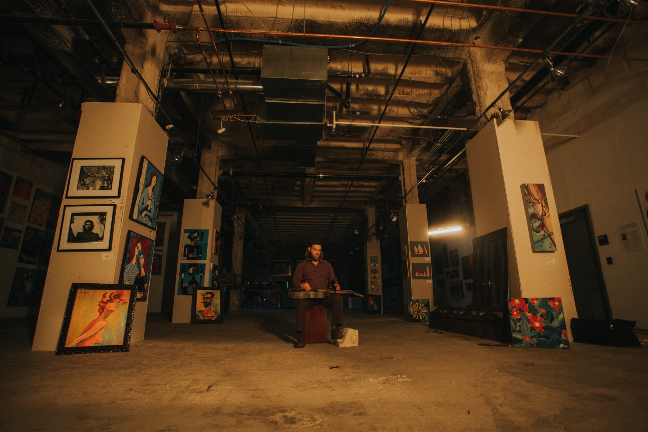Mark Lavengood playing dobro in a warehouse gallery